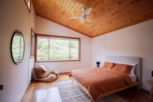 a bedroom with a bed and a ceiling fan at Nunyara - Mountain Views, Rural, Kangaroos, Birds 