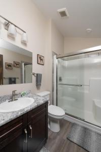 a bathroom with a shower and a sink and a toilet at Summit View in Valemount