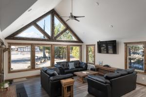 a living room with couches and a large window at Summit View in Valemount