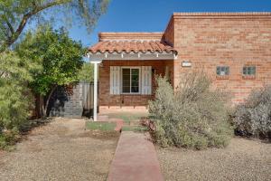a brick house with a pathway leading to the front door at Ideally Located Tucson Townhome 2 Mi to Downtown! in Tucson