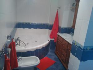a blue and white bathroom with a tub and a sink at Apartamento Nandy e Isa in Caleta De Velez +19 photos