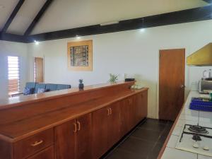 a kitchen with a wooden counter top in a room at Daku Resort in Savusavu