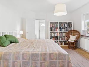 a bedroom with a bed and a book shelf at 7 person holiday home in Tranekær-By Traum in Tranekær