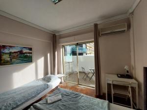 a bedroom with a bed and a window with a balcony at Lisbon`s best at Campo Pequeno in Lisbon