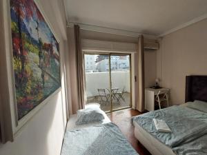 a small room with two beds and a window at Lisbon`s best at Campo Pequeno in Lisbon