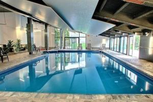 a large pool with blue water in a building at Le 219 Val des neiges in Beaupré