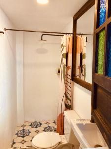 a bathroom with a toilet and a sink at Casa Aranjuez in Bogotá +65 photos