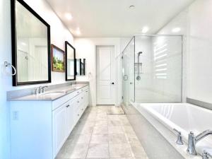 uma casa de banho com 2 lavatórios, uma banheira e um chuveiro em Refined Luxury Living in the Heart of Irvine! em Irvine
