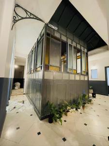 a building with glass doors and plants in a room at DOS SANTOS HOSTEL in Salta