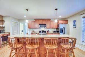 a kitchen with a large island with bar stools at Ellicottville Townhome with Hot Tub about 2 Mi to Skiing in Ellicottville