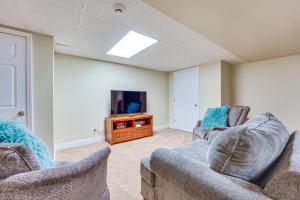 a living room with two couches and a tv at Ellicottville Townhome with Hot Tub about 2 Mi to Skiing in Ellicottville