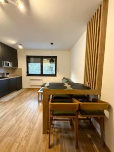 a dining room with a table and some chairs at Sofija Apartman Zlatibor in Zlatibor