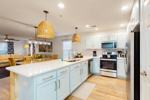 a kitchen with white cabinets and a counter top at The Fairways #D in Myrtle Beach