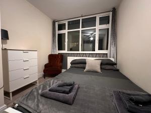 a bedroom with a large bed and a window at 5 Bed 5 Bath / Brick Lane Central London E1 in London