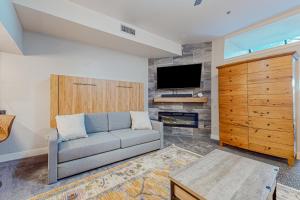 a living room with a couch and a flat screen tv at Park City Charmer in Park City