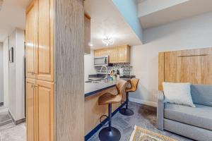 a small kitchen with a bar and a couch at Park City Charmer in Park City