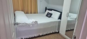 a bedroom with a bed with white sheets and pillows at Home Away Comfort stay in Suva
