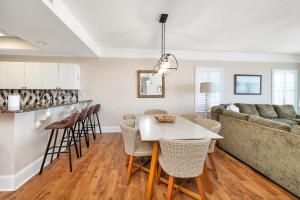 a kitchen and living room with a table and a couch at St. Simons Grand # 307 in Saint Simons Island