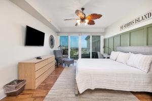 a bedroom with a king sized bed and a tv at St. Simons Grand # 307 in Saint Simons Island
