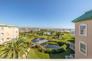 an aerial view of a resort with a pond and palm trees at St. Simons Grand # 307 in Saint Simons Island