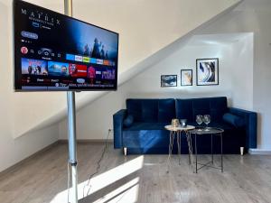 sala de estar con sofá azul y TV de pantalla plana en Design Apartment, Küche, Smart-TV, WLAN, en Essen