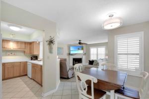 a kitchen and living room with a table and a dining room at Harbour Oaks 311 in Saint Simons Island