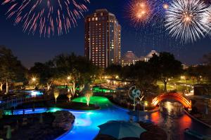 Blick auf einen Pool mit Feuerwerk in der Stadt in der Unterkunft Hilton Anatole in Dallas