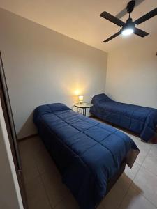 a bedroom with two beds and a ceiling fan at Consorcio San Ignacio in San Juan