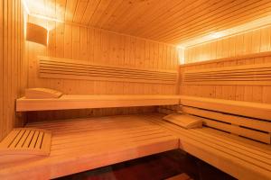 a wooden sauna with wooden shelves and wooden floors at Best Western Hotel & SPA Pau Lescar Aeroport in Lescar