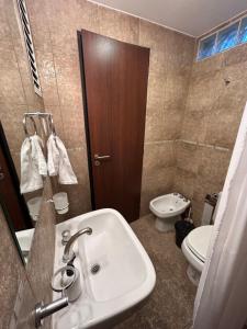 a bathroom with a sink and a toilet at Consorcio San Ignacio in San Juan