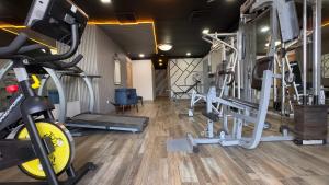 a gym with several tread machines and a treadmill at Hotel Quinta Real in La Ceiba