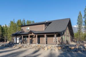 a log home with a black roof at Sunny Peaks in Valemount