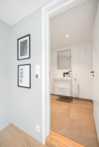 a white hallway with a white sink and a mirror at Apartment in Greenland, Oslo in Oslo