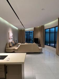 un ampio soggiorno con un grande letto e un divano di HAFAL Resort شاليهات هافال a Riyad