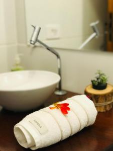 a white towel on a table next to a sink at Canto do Una- hospedagem in Barra do Una