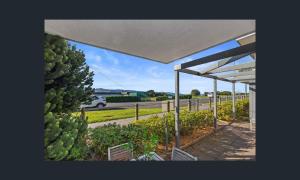 a view of a garden from under a pavilion at Apollo Blue Oceanview Unit 1- B Free WIFI in Apollo Bay