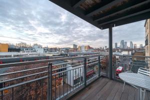 a balcony with a view of a city at Victoria Brand new, cosy 1 bed apartment in London