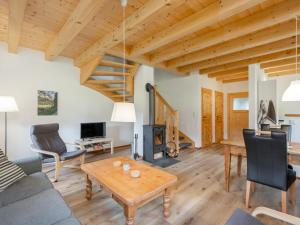 een woonkamer met een tafel en een open haard bij Wolfgangchalet C in Mauterndorf