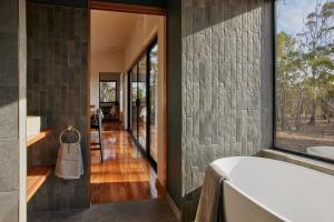 a room with a large window and a bath tub at Arden Retreat - The Croft at Richmond in Richmond