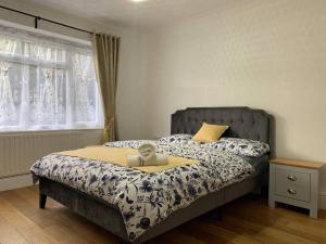 a bedroom with a bed and a window at Luxury Two Bed Deluxe Maisonette in Wrecclesham