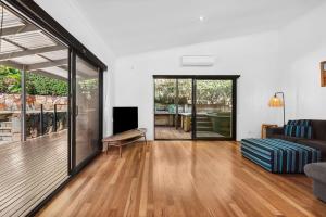 a living room with a couch and a television in it at 252 David Low Way in Peregian Beach