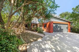 a house with a driveway with a garage at 252 David Low Way in Peregian Beach