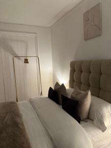 a bedroom with a large white bed with pillows at Artistic Two bedroom apartment in London