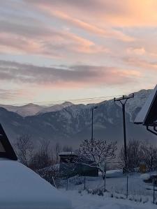 a view of a snowy mountain with mountains in the distance at Domek na Górce in Zakopane