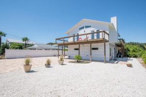 a large house on the beach with potted plants at Bright New Beach House with In- Law Suite -- 2 blocks to beach! in Saint Augustine