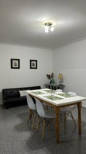 a living room with a table and a couch at Departamento Centro in Olavarría +7 photos