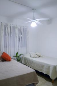 a bedroom with two beds and a ceiling fan at LA CASA DE LA NONA in Guaymallen