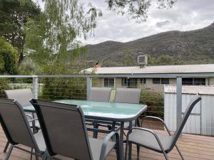 a patio with a table and chairs on a deck at 3 Bedroom Holiday house in Halls Gap