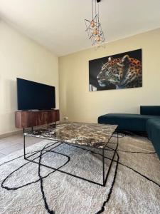 a living room with a couch and a coffee table at Villa ski proche de Genève et du Jura in Saint-Genis-Pouilly +11 photos