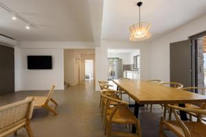 a dining room with a wooden table and chairs at Aegean Gem Villa with private pool in Paros in Mármara